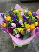 Bright and colourful spring bouquet featuring pink tulips, purple ...