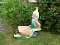 plastic garden Gnome pushing wheelbarrow