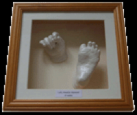 framed hand and foot baby cast. “